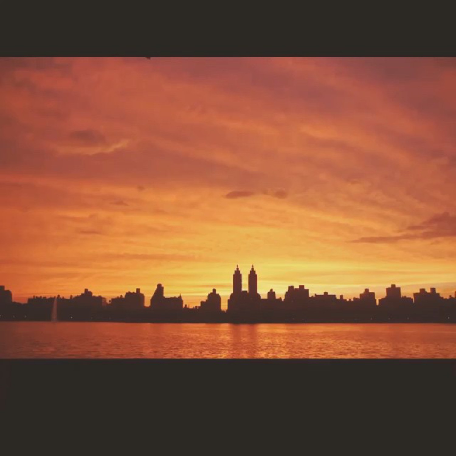 Central Park lake at sunset on Manhattan's Upper East Side near East 77th Street apartments